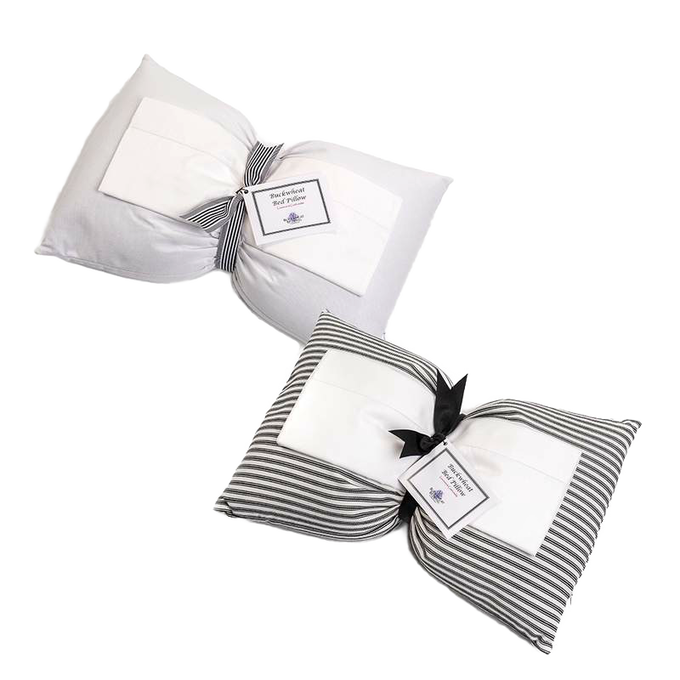 Two handcrafted buckwheat bed pillows, one solid white and one with gray and white stripes, tied with black ribbons and labels, part of Home & Decor and USA Made collections.
