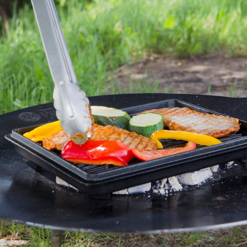 Square cast iron griddle pan grilling colorful bell peppers, zucchini slices, and seasoned meat over outdoor coals, perfect for Farm, Garden & Tool, Kitchen & Food, Camping, and Cookware collections.