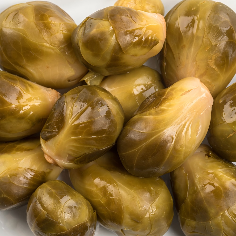 Close-up of glossy pickled Brussels sprouts with a tangy, spiced finish, handcrafted and made in USA, ideal for Kitchen & Food, Pantry, Best Sellers, and Promo Eligible collections.