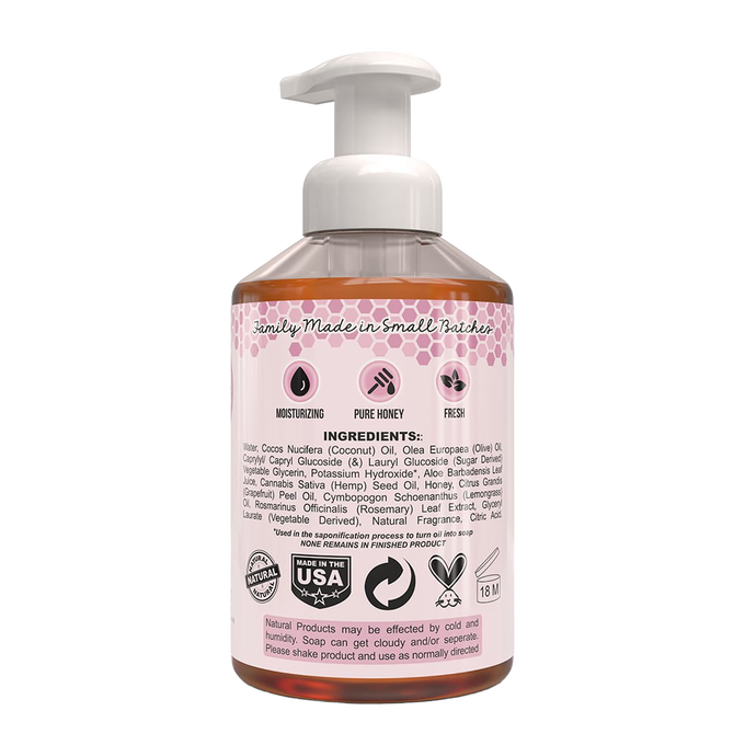 Clear plastic pump bottle of natural foaming hand soap with label listing moisturizing, pure honey, and fresh qualities, made in USA, featured in Health & Wellness and Soaps collections.