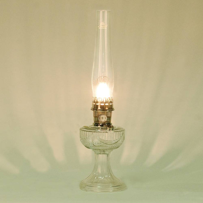 Handcrafted clear glass lamp with an embossed drape pattern, featuring a bright brass burner and tall chimney, part of Lamps & Lighting, Oil Lamps, Table Lamps, Best Sellers, and Promo Eligible collections.