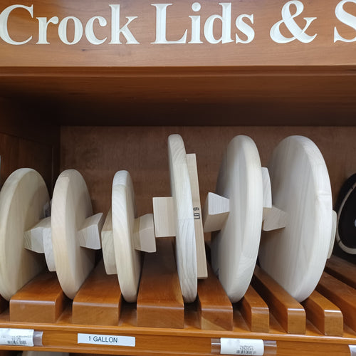 Locally handmade unfinished poplar wooden lids with support bars in various sizes, displayed on wooden shelves, ideal for Kitchen & Food, Food Preservation, Fermenting and Pickling, USA Made, and Best Sellers collections.