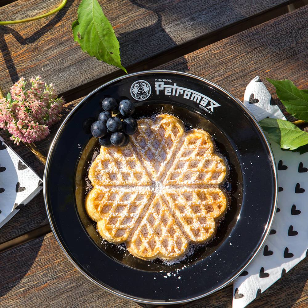 Black enamel plate with Petromax branding holding a heart-shaped waffle dusted with powdered sugar and a small bunch of grapes, ideal for camping, kitchen, and outdoor dining in Farm, Garden & Tool, Dinnerware, Best Sellers, and Promo Eligible collections.