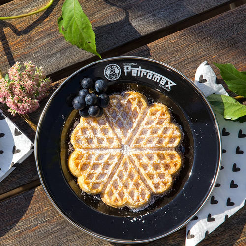 Black enamel plate with Petromax branding holding a heart-shaped waffle dusted with powdered sugar and a small bunch of grapes, ideal for camping, kitchen, and outdoor dining in Farm, Garden & Tool, Dinnerware, Best Sellers, and Promo Eligible collections.