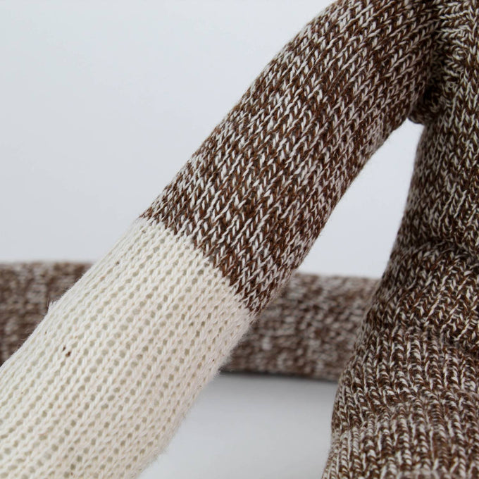 Close-up of a handcrafted arm on a brown and cream knit sock monkey made in USA, featured in Toys, Books & Games, Children's Toys, Indoor Play, and Best Sellers collections.