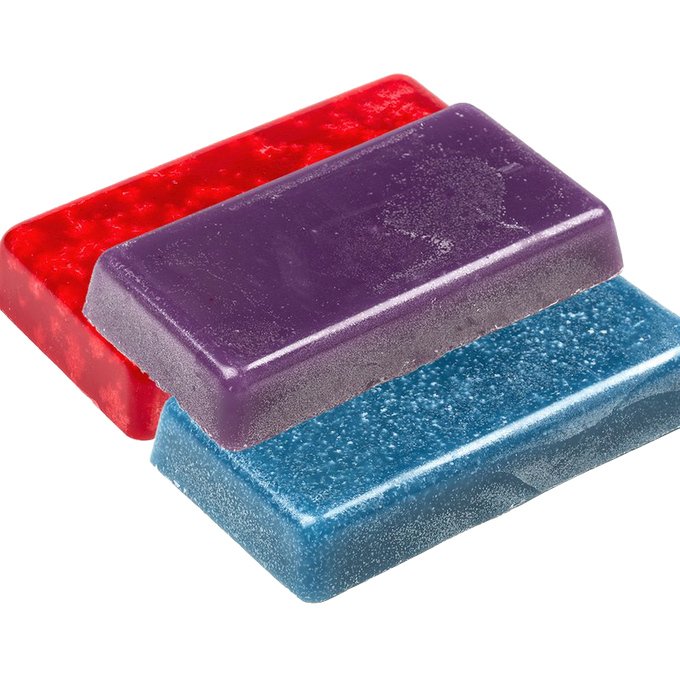 Three smooth blocks of colored scented candle wax in red, purple, and blue, handcrafted for candlemaking supplies and ideal for lamps and lighting collections.