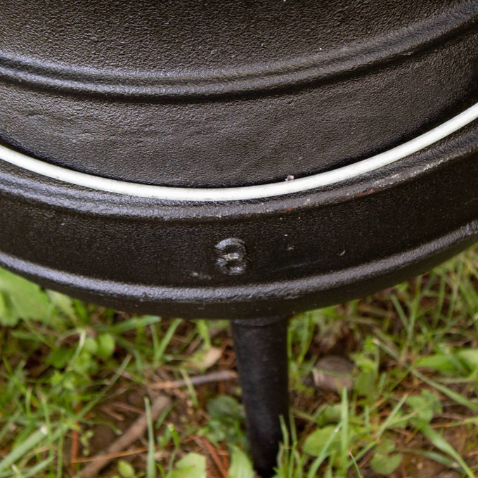 Close-up of handcrafted cast iron campfire kettle leg and base showing durable construction and embossed size marking, designed for outdoor cooking in Farm, Garden & Tool, Camping, Best Sellers, and Promo Eligible collections.