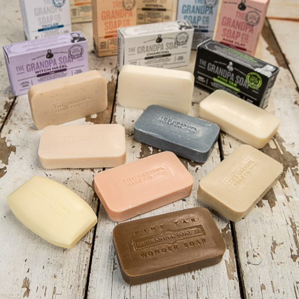 Assorted handcrafted bars of Grandpa's Charcoal Bar Soap and other natural varieties with embossed branding, featured in Health & Wellness, Grooming, Soaps, USA Made, and Best Sellers collections.