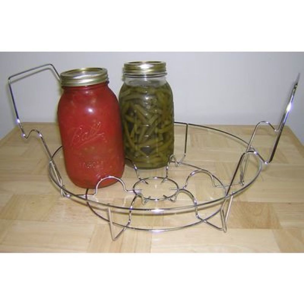 Round stainless steel canning rack holding two sealed glass jars of preserved tomatoes and green beans, designed for use in water bath canners in food preservation and kitchen collections.