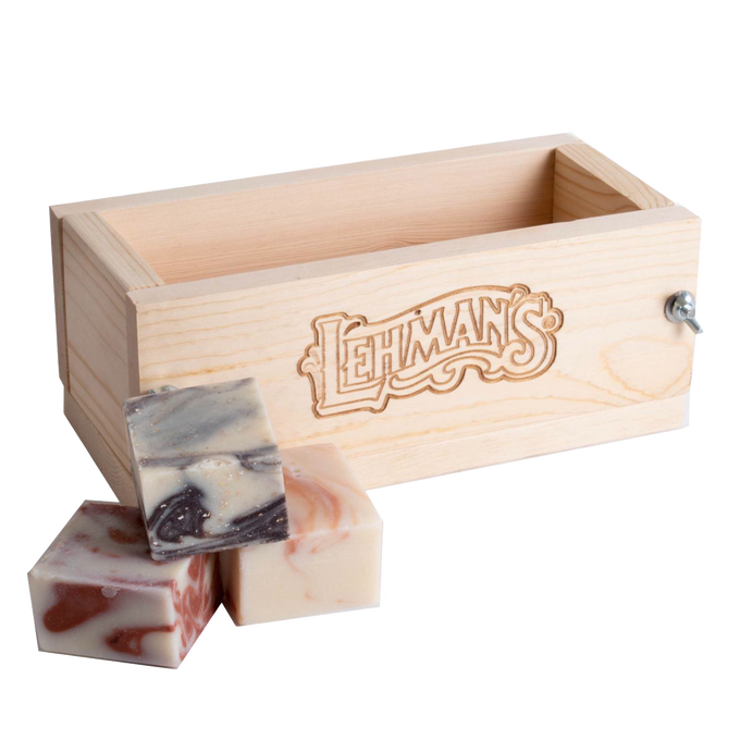 Handcrafted wooden soap loaf mold made from durable pine with engraved branding, accompanied by three artisan soap bars, featured in Health & Wellness and Soaps and Soapmaking collections.