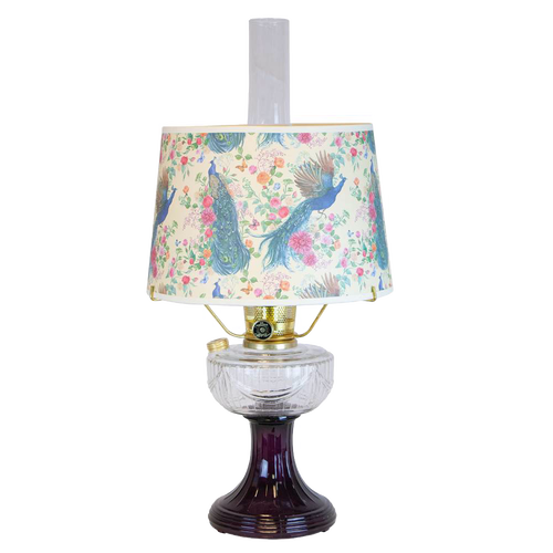 Handcrafted oil lamp featuring a clear glass bowl over an amethyst pedestal base with a floral and peacock patterned shade, perfect for lamps & lighting and table lamps collections.