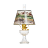 Clear oil lamp with brass burner and a Rocky Mountain scenic parchment shade depicting a moose by a lake with mountains in the background, featured in Lamps & Lighting, Oil Lamps, Table Lamps, Best Sellers, and Promo Eligible collections.