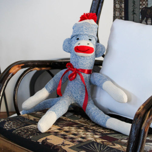 Handcrafted blue and white sock monkey with red ribbon bow and pom-pom hat, made in USA, featured in Toys, Books & Games, Children's Toys, Indoor Play, Best Sellers, and Promo Eligible collections.