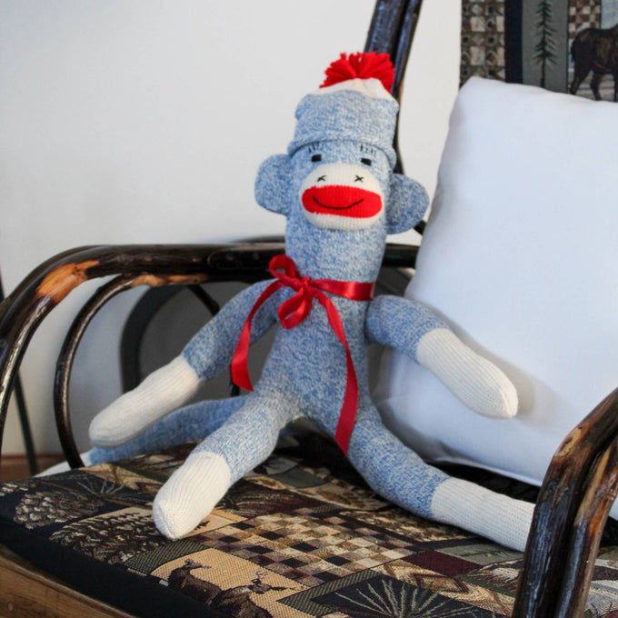 Handcrafted blue and white sock monkey with red ribbon bow and pom-pom hat, made in USA, featured in Toys, Books & Games, Children's Toys, Indoor Play, Best Sellers, and Promo Eligible collections.