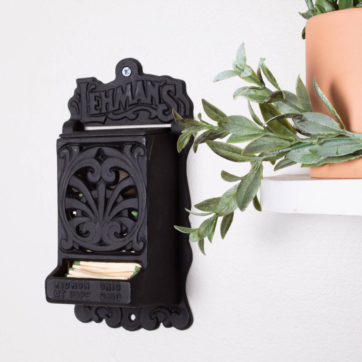 Handcrafted black vintage-style wall-mounted matchbox holder with decorative scrollwork, made in USA, perfect for Home & Decor, Household Helpers, and Best Sellers collections.
