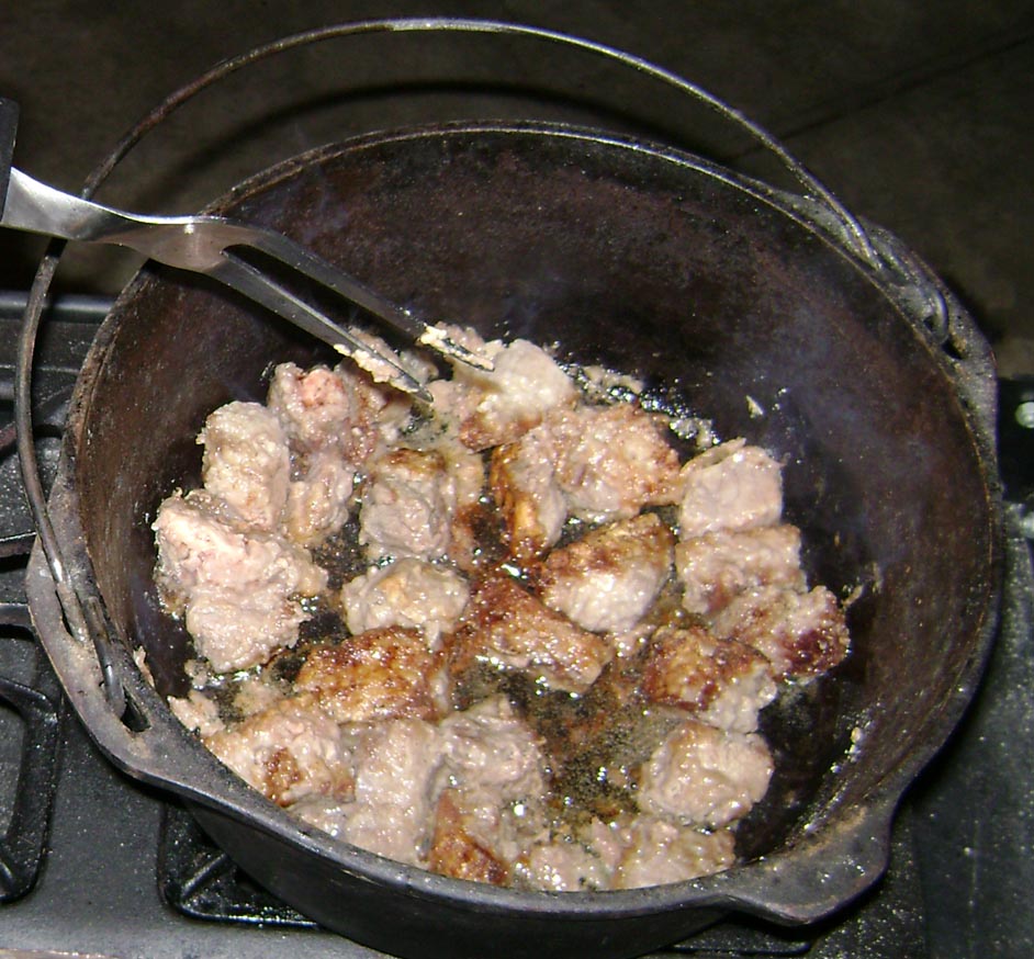 Browning beef Browning beef in flat-bottom cast iron pot.