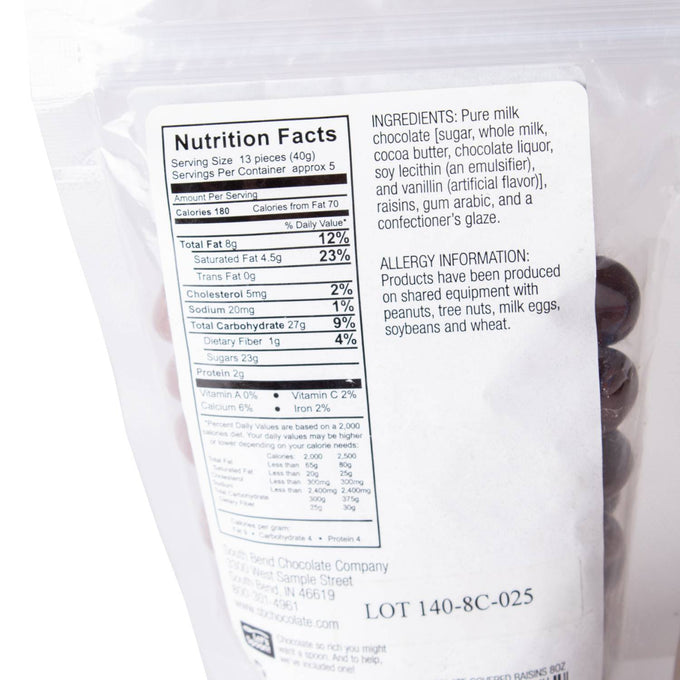 Back of a resealable bag showing nutrition facts, ingredient list, and allergy information for handcrafted milk chocolate covered raisins, made in USA, featured in Kitchen & Food, Snacks and Sweets, Candy, USA Made, Best Sellers, and Promo Eligible collections.