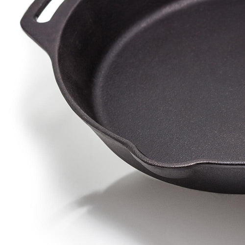 Close-up of a handcrafted cast iron skillet with two side handles and a pouring spout, ideal for use in farm, garden, kitchen, camping, cookware, and cast iron collections.