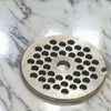 Round stainless steel grinder plate with uniform circular holes, designed for use with meat grinder equipment, made in USA, ideal for Kitchen & Food, Specialty Equipment, Butchering Supplies, USA Made, Best Sellers, Promo Eligible collections.