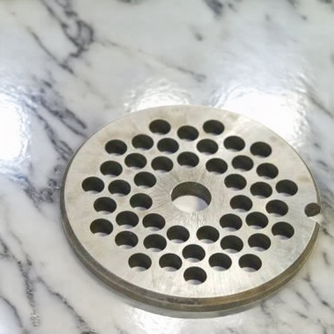 Round stainless steel grinder plate with uniform circular holes, designed for use with meat grinder equipment, made in USA, ideal for Kitchen & Food, Specialty Equipment, Butchering Supplies, USA Made, Best Sellers, Promo Eligible collections.