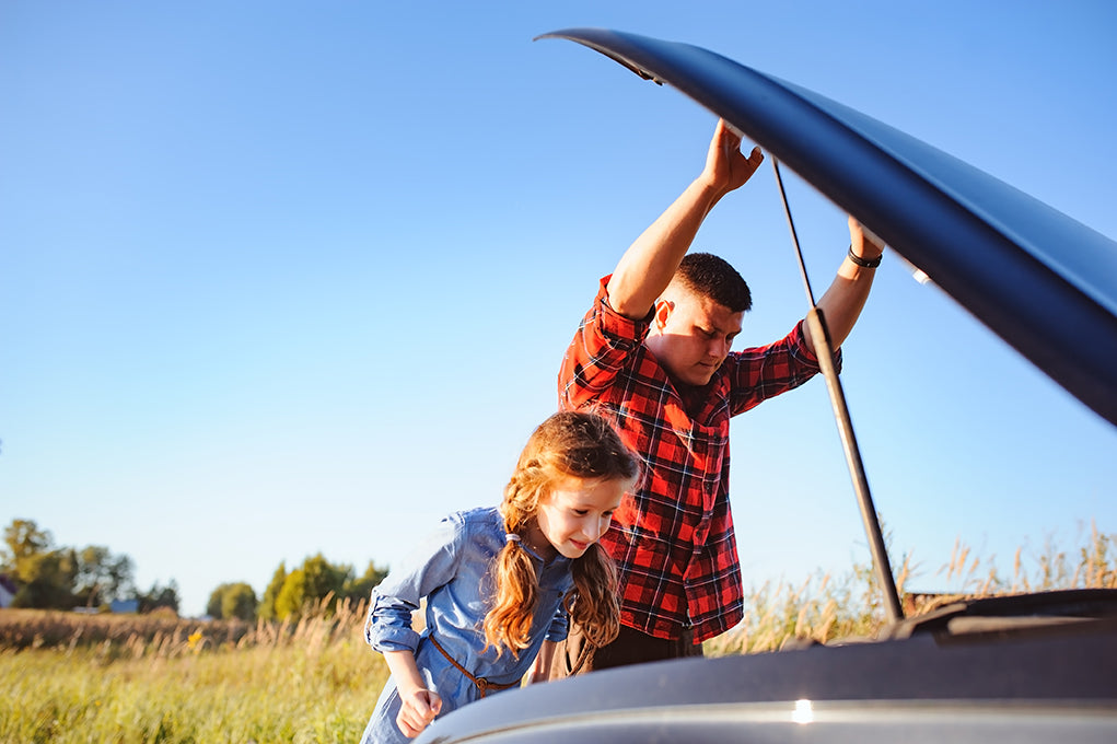 daughter and father with car