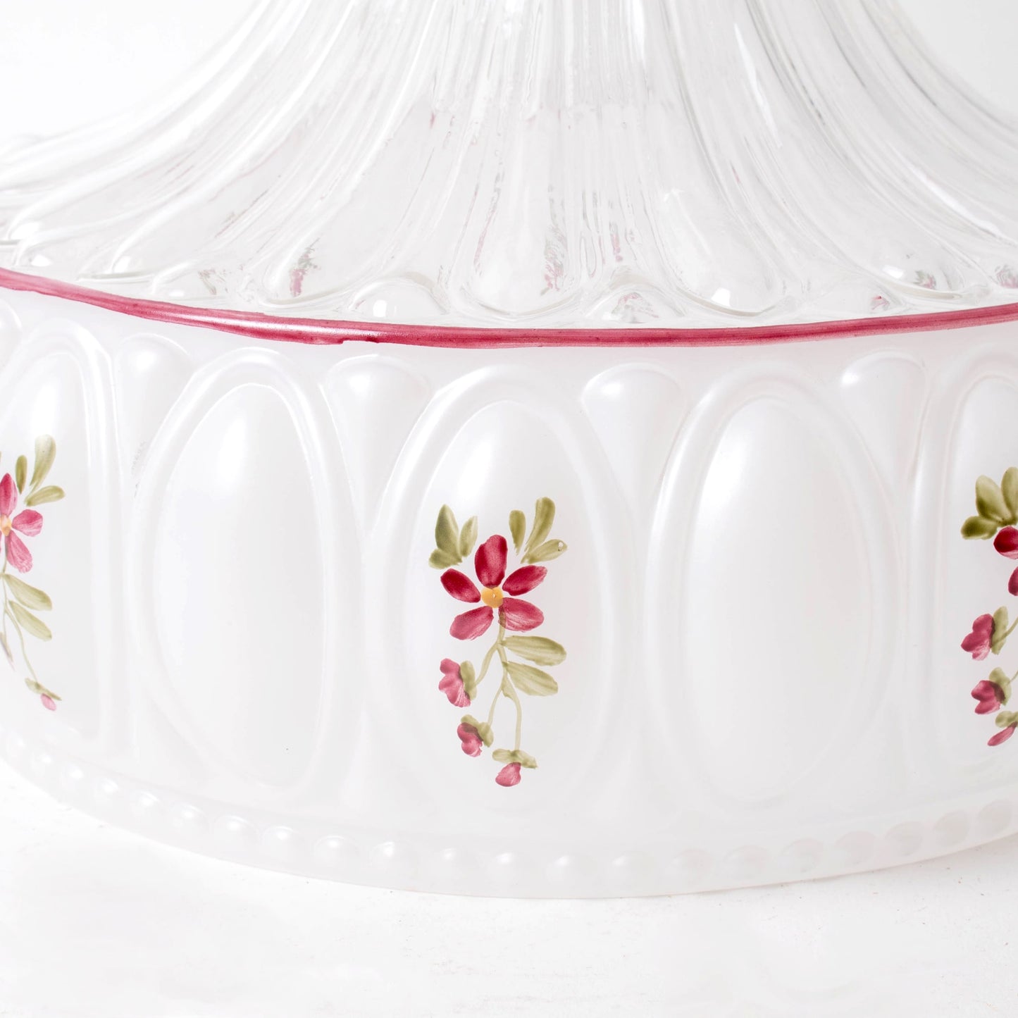 Close-up of a handcrafted glass oil lamp base with embossed oval patterns and delicate hand-painted floral accents, ideal for farm, garden, and homesteading decor.