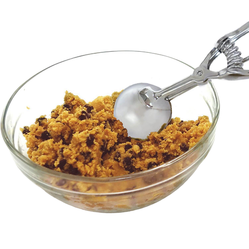 Handcrafted metal scoop with spring release resting in a glass bowl filled with chocolate chip cookie dough, perfect for Kitchen & Food, Cookware, Baking Supplies, Kitchen Gadgets, and Best Sellers collections.