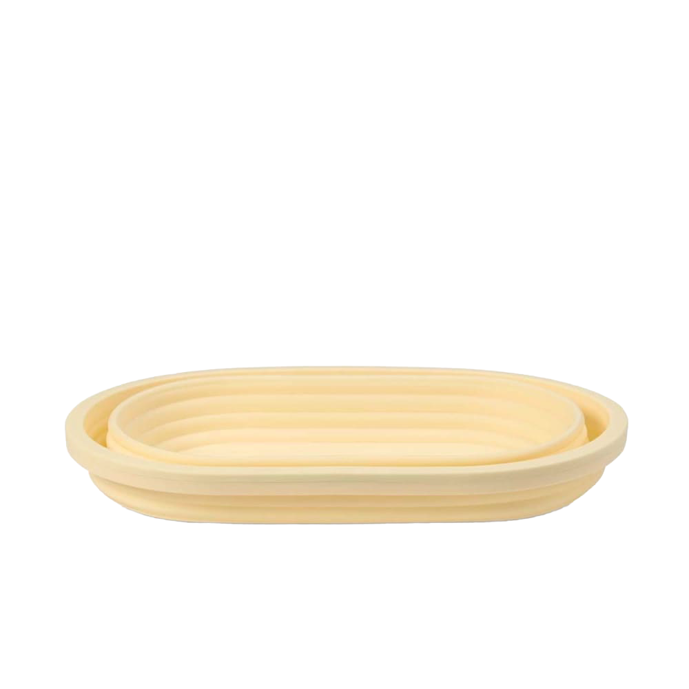 Light beige collapsible bread proofing basket with concentric ridges, crafted from durable silicone and steel rim for shaping dough and convenient storage in Kitchen & Food and Baking Supplies collections.