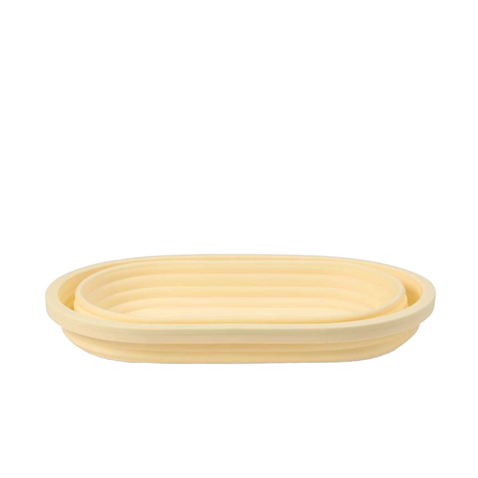 Light beige collapsible bread proofing basket with concentric ridges, crafted from durable silicone and steel rim for shaping dough and convenient storage in Kitchen & Food and Baking Supplies collections.