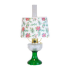 Handcrafted oil table lamp with clear over emerald glass base and festive parchment shade decorated with red poinsettias and green holly, featured in Lamps & Lighting and Best Sellers collections.
