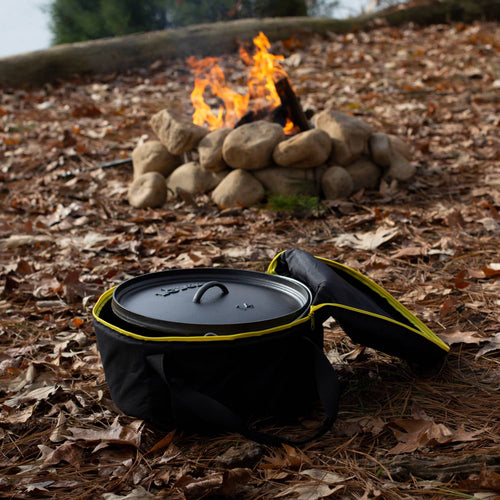 Black and yellow padded tote bag made from weather-resistant polyester, designed for secure transport and storage of cast iron cookware near a campfire, perfect for camping and outdoor use.