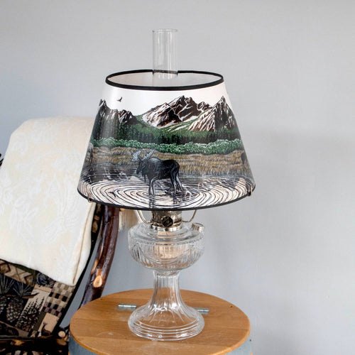 Handcrafted parchment oil lamp shade featuring a Rocky Mountain scene with a moose standing in a pond, designed to soften light for lamps and lighting, parts and accessories, and lamp shades collections.