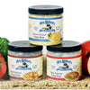 Three 12-oz canisters of handcrafted Amish-made soup bases in chicken, beef, and ham flavors, gluten-free and no MSG, displayed with fresh vegetables for Kitchen & Food, Dry Goods and Mixes, Soups, Gluten Free, USA Made, Best Sellers, and Promo Eligible collections.