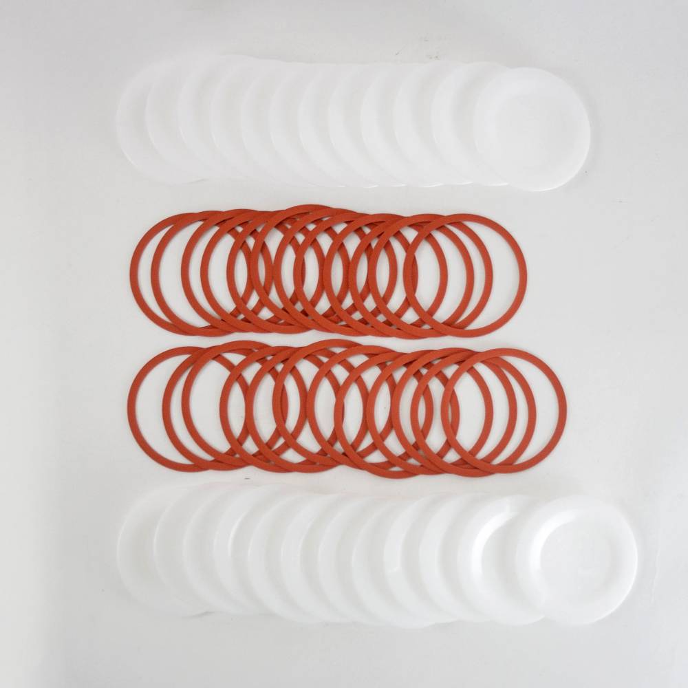 Set of reusable wide-mouth canning jar lids and orange sealing rings, designed for food preservation and kitchen use, featured in USA Made and Best Sellers collections.