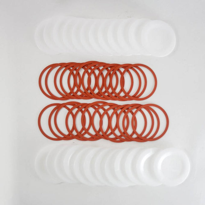 Set of reusable wide-mouth canning jar lids and orange sealing rings, designed for food preservation and kitchen use, featured in USA Made and Best Sellers collections.