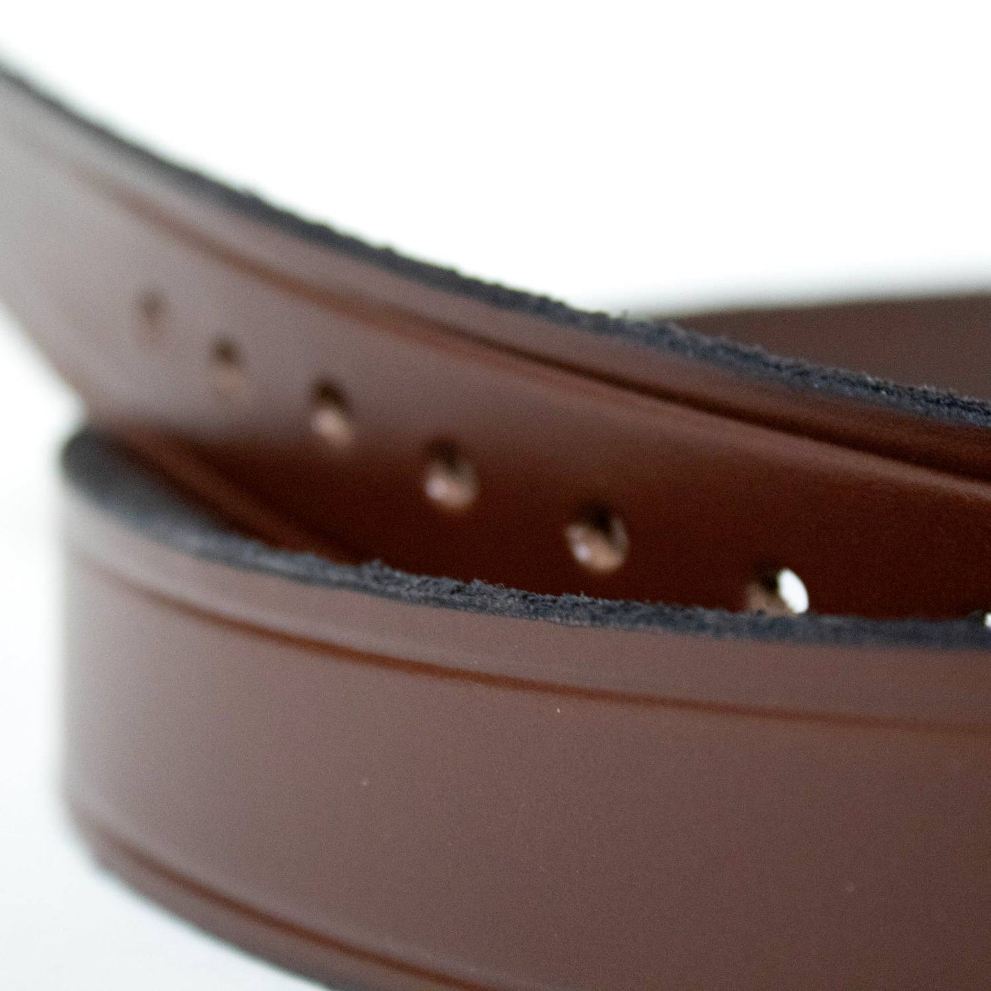 Close-up of a handcrafted brown genuine cowhide leather belt with visible punched holes and natural edge texture, highlighting Amish-made quality in Health & Wellness, USA Made collections.
