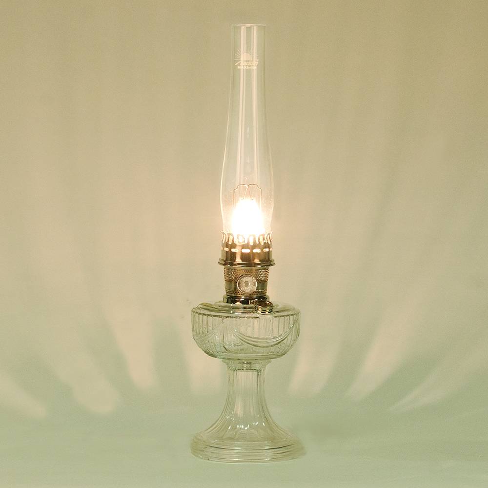 Handcrafted clear glass oil lamp with polished brass burner and tall chimney featuring an elegant drape pattern, made in USA, part of Lamps & Lighting, Oil Lamps, Table Lamps, Best Sellers, Promo Eligible collections.