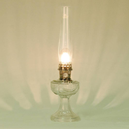 Handcrafted clear glass oil lamp with polished brass burner and tall chimney featuring an elegant drape pattern, made in USA, part of Lamps & Lighting, Oil Lamps, Table Lamps, Best Sellers, Promo Eligible collections.