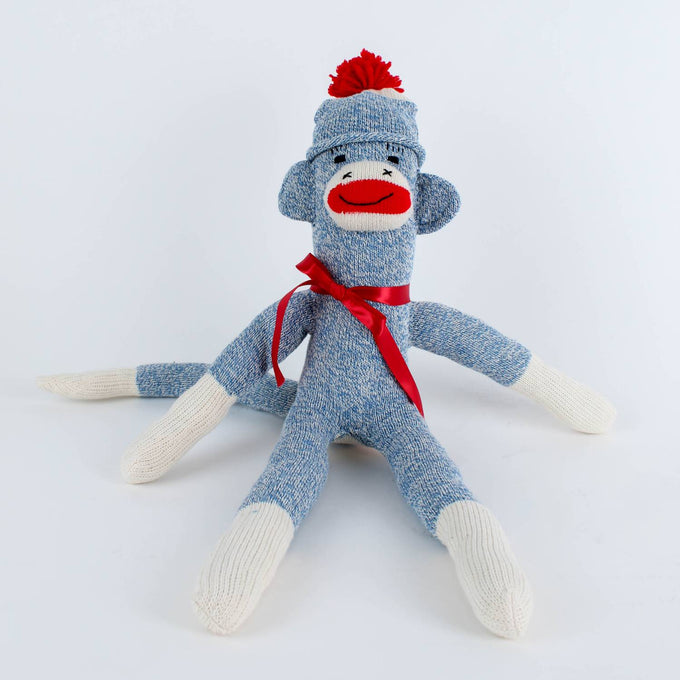 Handcrafted blue and white hand-sewn sock monkey wearing a red pom-pom hat and ribbon bow, made in USA, featured in Toys, Books & Games, Children's Toys, Indoor Play, and Best Sellers collections.
