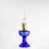 Handcrafted cobalt glass oil lamp with brass burner and tall clear chimney, featuring a Lincoln drape pattern, ideal for Lamps & Lighting, Oil Lamps, Table Lamps, Best Sellers, and Promo Eligible collections.