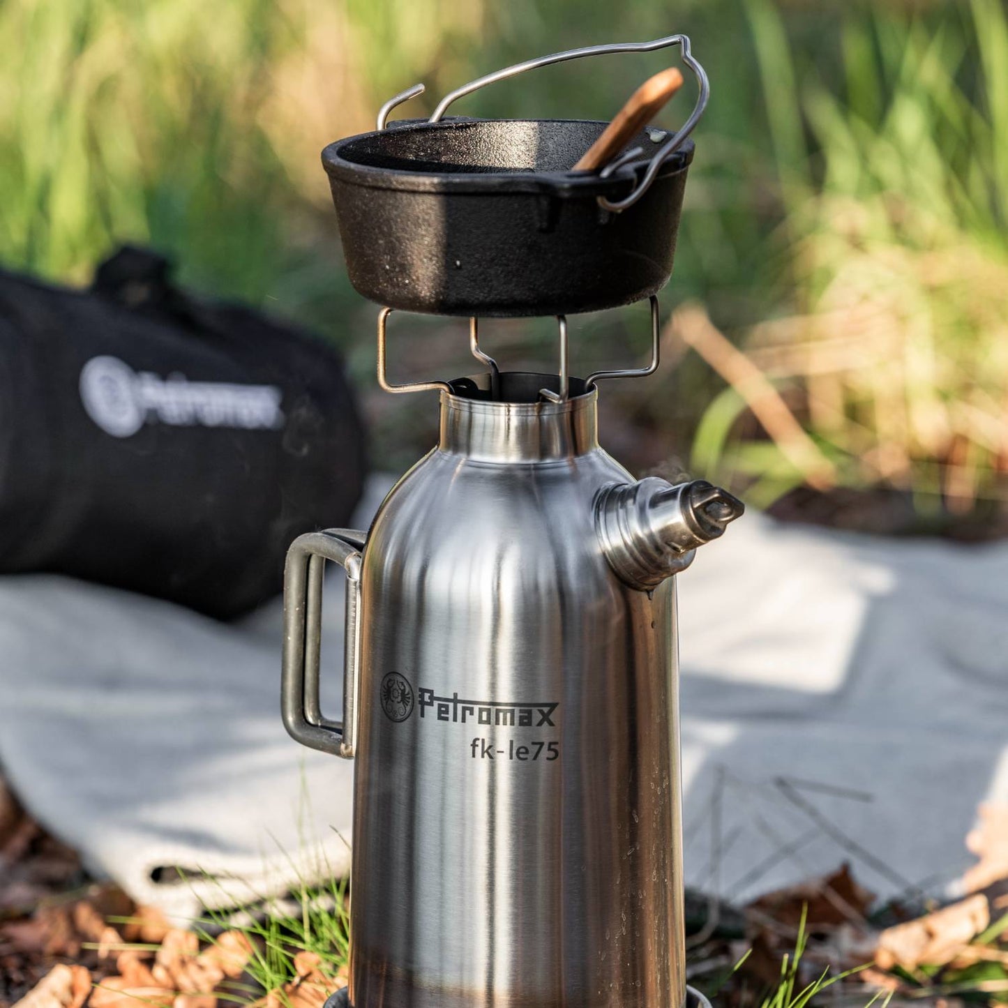 Handcrafted stainless steel fire kettle with sturdy handle and screw-on spout, featuring a cast iron pot on top; ideal for Camping, Farm, Garden & Tool, Emergency Supplies, and Best Sellers collections.
