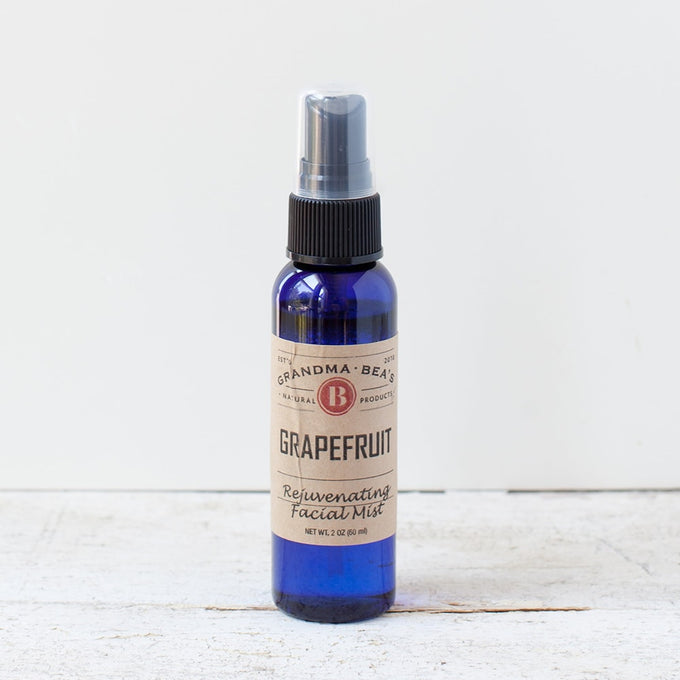 Blue glass spray bottle of handcrafted grapefruit facial mist with natural ingredients, featured in Health & Wellness, Grooming and Personal Hygiene, USA Made, Best Sellers, and Promo Eligible collections.