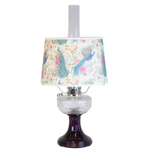 Handcrafted oil lamp featuring a clear glass font over an amethyst pedestal base with a decorative peacock-patterned shade, part of Lamps & Lighting, Oil Lamps, and Best Sellers collections.