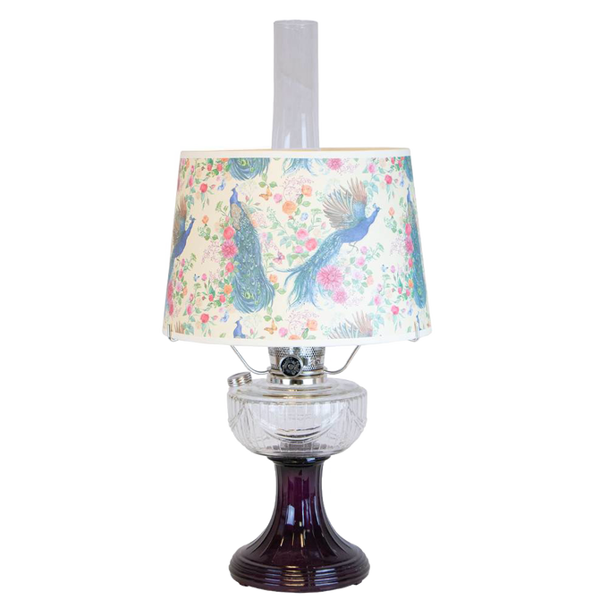 Handcrafted oil lamp featuring a clear glass font over an amethyst pedestal base with a decorative peacock-patterned shade, part of Lamps & Lighting, Oil Lamps, and Best Sellers collections.