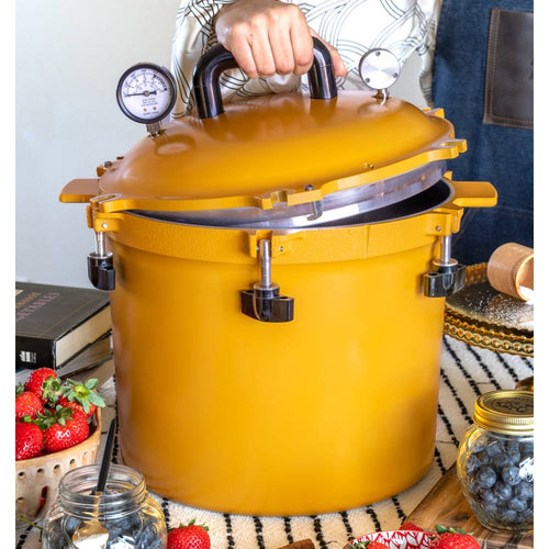 Vibrant yellow 21.5-quart pressure canner with secure locking lid, dual pressure gauges, and sturdy handles, designed for safe food preservation in Kitchen & Food, Canning, and USA Made collections.