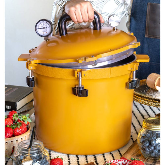 Vibrant yellow 21.5-quart pressure canner with secure locking lid, dual pressure gauges, and sturdy handles, designed for safe food preservation in Kitchen & Food, Canning, and USA Made collections.