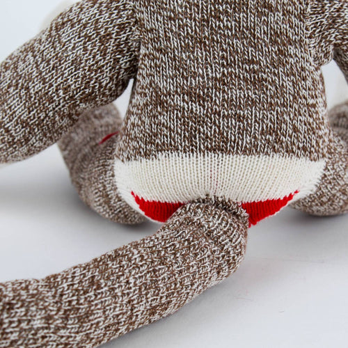 Close-up of the lower back and tail of a handcrafted brown and cream knit monkey made from classic red and white heel socks, featured in Toys, Books & Games, USA Made, Children's Toys, Indoor Play, Best Sellers, and Promo Eligible collections.