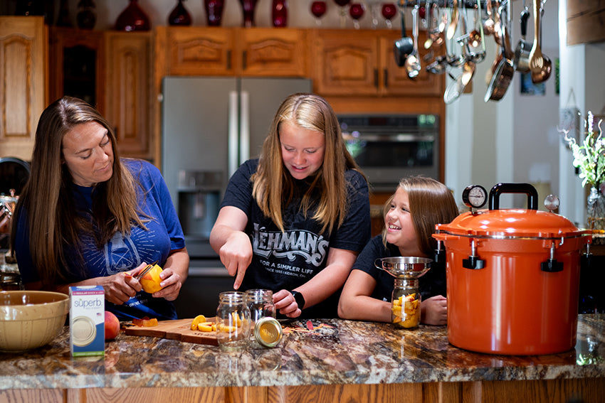 Family canning food in canner