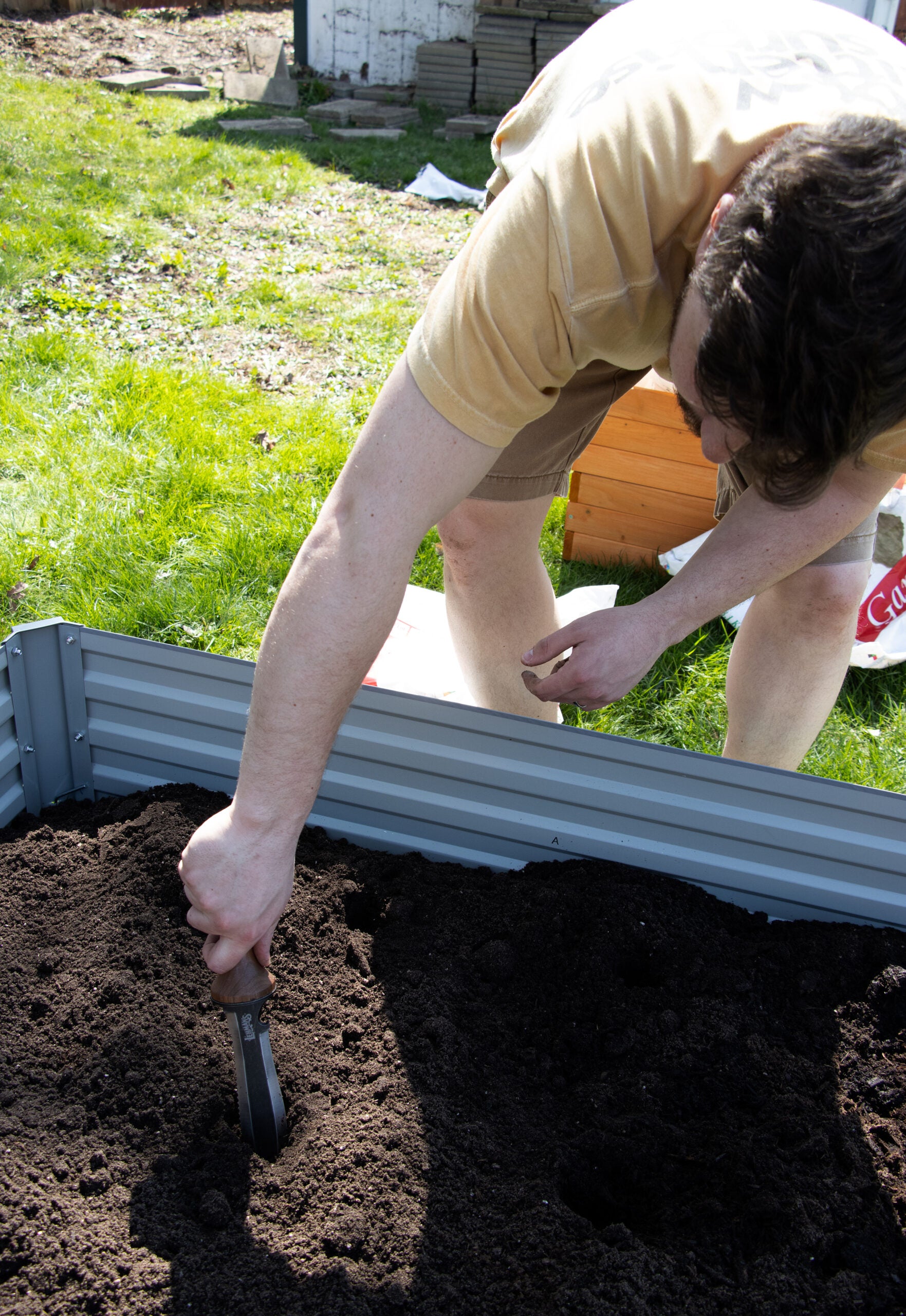 A Hori Hori Garden knife is used to dig holes for seeds.