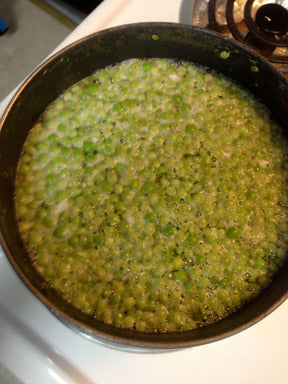 Fill the saucepan half-way with water, and bring it to a boil. I added the peas to blanch (at a rolling boil) for a minute and an half.